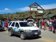 A thumb nail view of Grand Lake, Colorado during Constitution Week in September looking at a Park Ranger driving the Rocky Mountain National Park SUV in the Parade; click here to open a window with a larger picture.